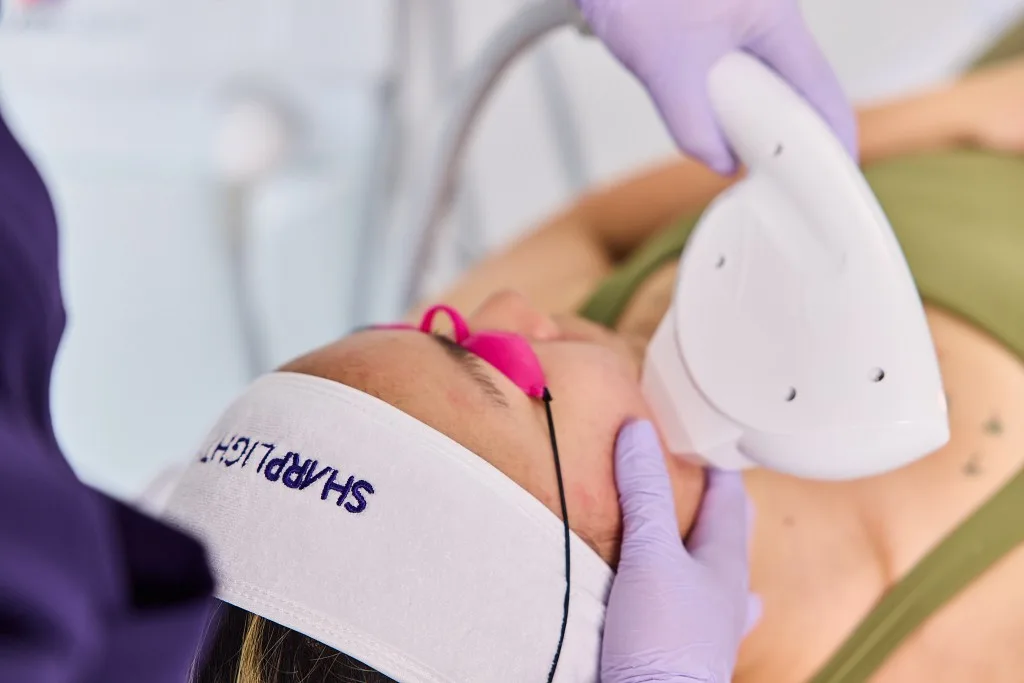 Patient receiving a comfortable acne treatment session with protective eyewear