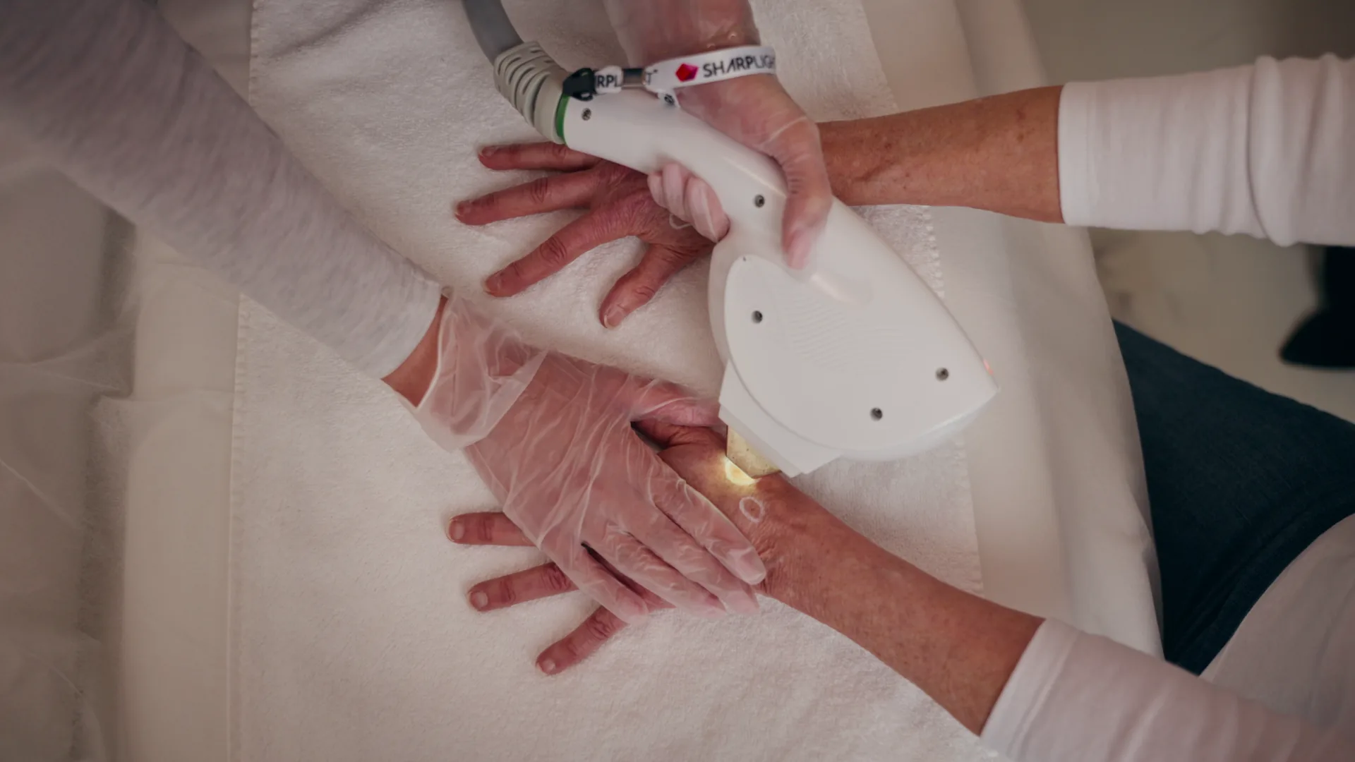 Practitioner delivering an OmniMax S4 DPC treatment to the hand